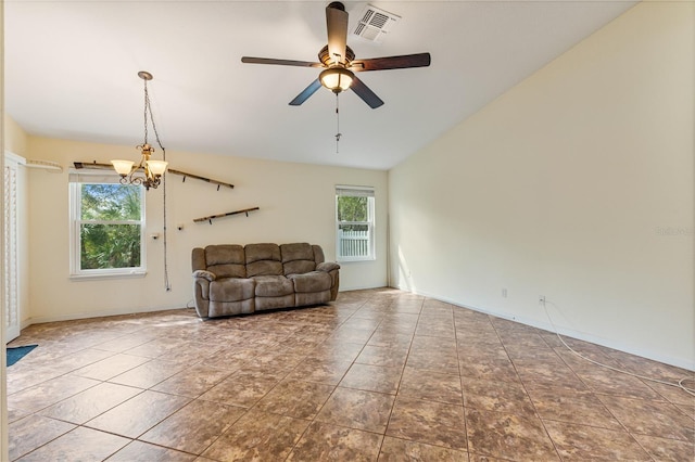 unfurnished living room with ceiling fan with notable chandelier, lofted ceiling, visible vents, and tile patterned floors