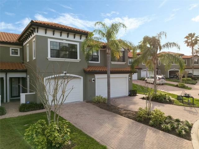 mediterranean / spanish home featuring a garage