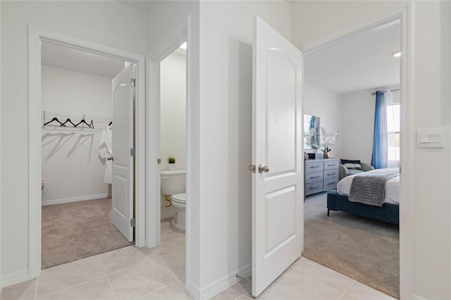 hallway with light colored carpet