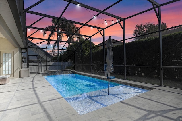 view of pool with a patio, glass enclosure, and a fenced in pool