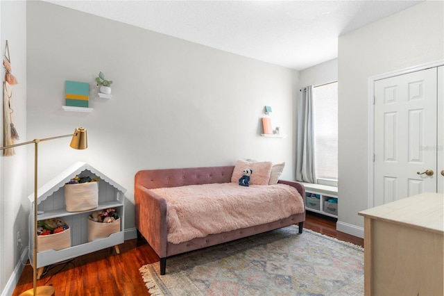 bedroom featuring baseboards and wood finished floors