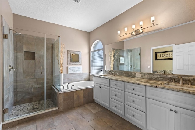 bathroom with double vanity, a sink, a shower stall, and a bath