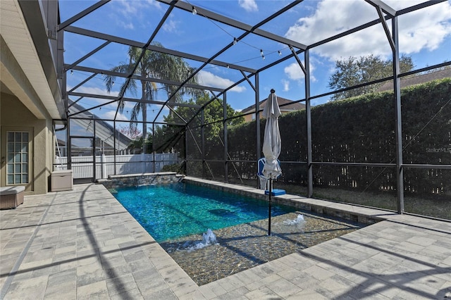 pool featuring a lanai, fence, and a patio