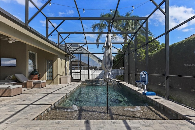 view of swimming pool with a patio, a lanai, a ceiling fan, and fence