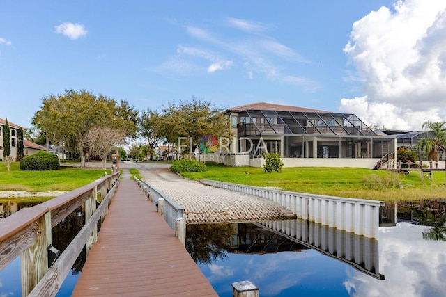 dock area featuring a lawn and a water view