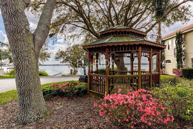 exterior space featuring a gazebo and a water view