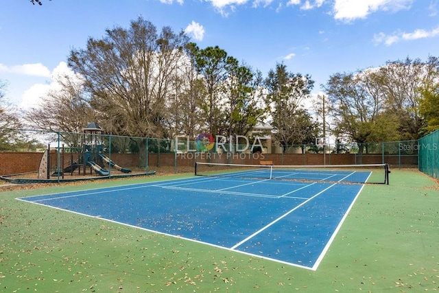 view of tennis court with fence and playground community