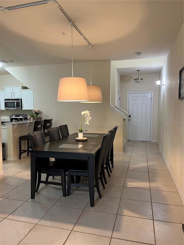 dining area featuring light tile patterned floors