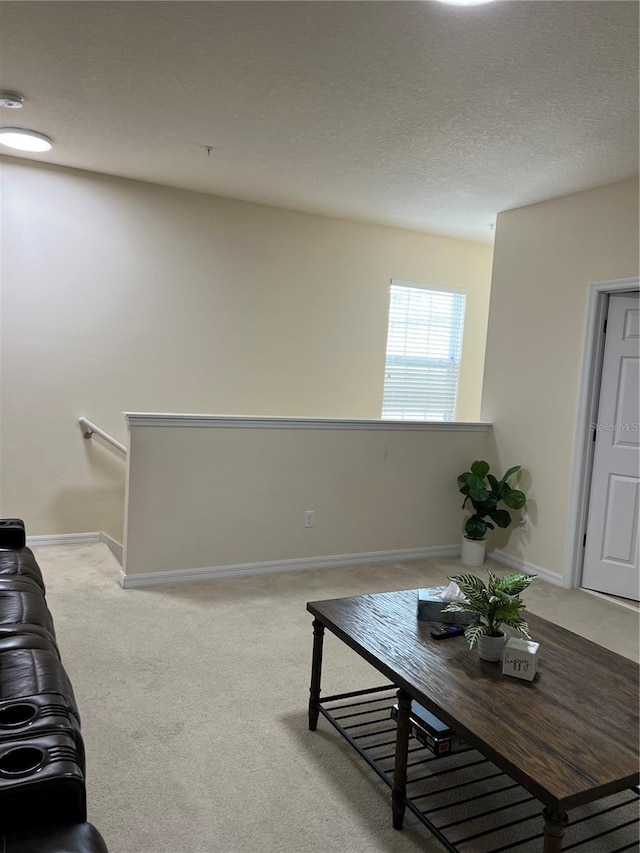 living room with light carpet and a textured ceiling