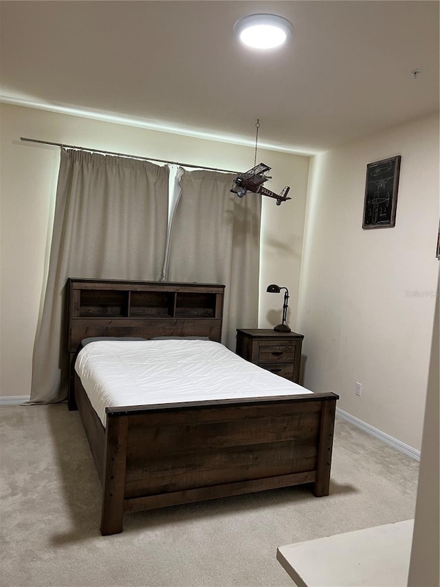 bedroom featuring light colored carpet