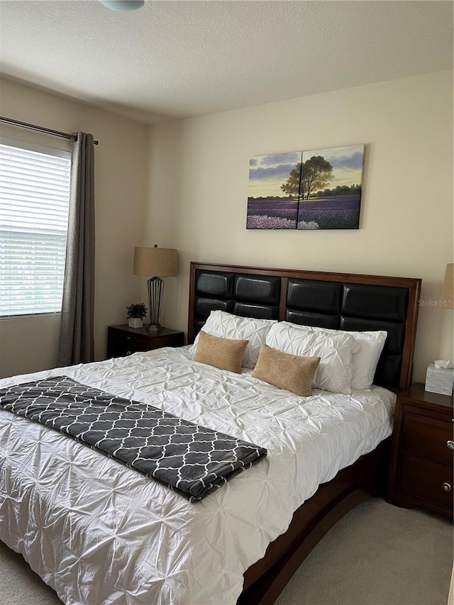 carpeted bedroom with a textured ceiling