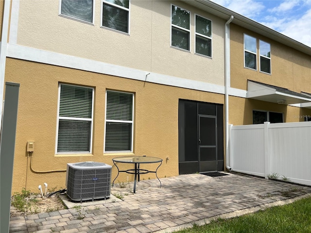 back of property featuring a patio area and central air condition unit