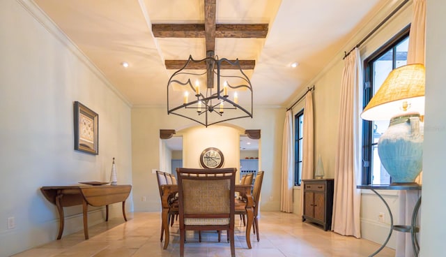 dining area featuring light tile patterned floors, ornamental molding, an inviting chandelier, and baseboards