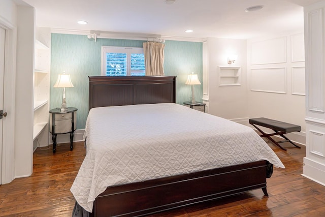 bedroom with baseboards, wood finished floors, and recessed lighting