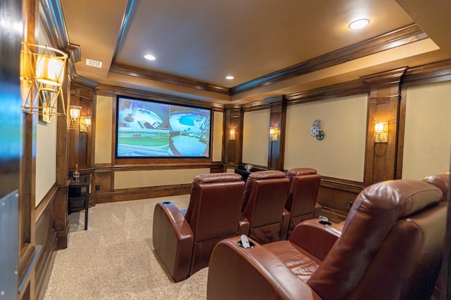 carpeted home theater room with recessed lighting, a decorative wall, visible vents, ornamental molding, and a raised ceiling