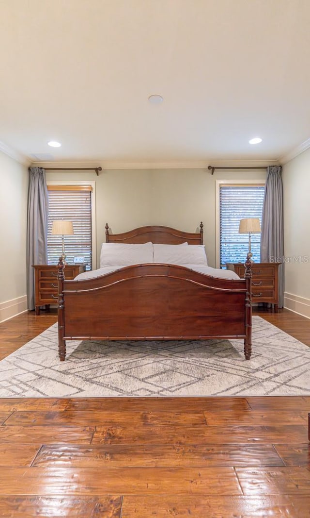 unfurnished bedroom featuring ornamental molding, wood-type flooring, recessed lighting, and baseboards