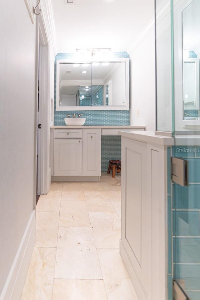 bathroom with crown molding and vanity