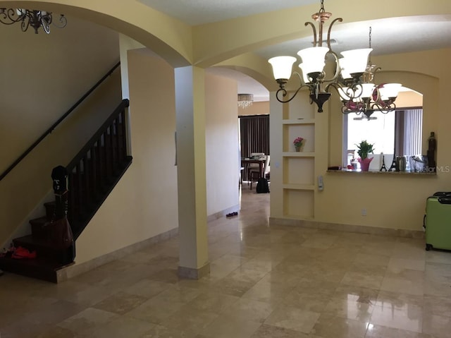 unfurnished dining area featuring an inviting chandelier