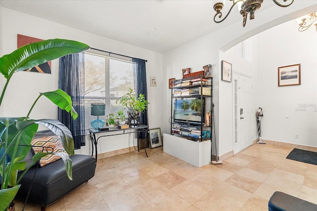 interior space with baseboards and a notable chandelier