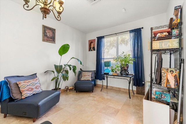 sitting room with baseboards, visible vents, and an inviting chandelier