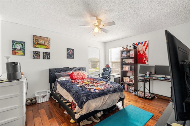 bedroom featuring a textured ceiling, wood finished floors, and a ceiling fan