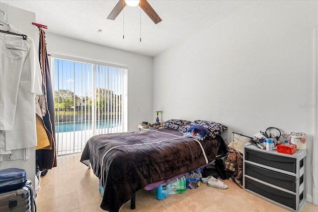 bedroom featuring access to exterior and a ceiling fan