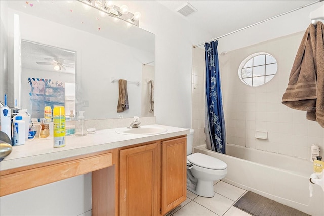 bathroom with plenty of natural light, vanity, shower / bath combo with shower curtain, and tile patterned floors