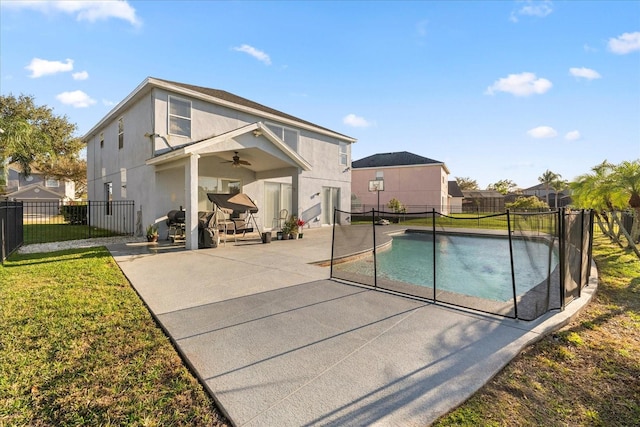 view of pool with a fenced backyard, a ceiling fan, a fenced in pool, and a patio