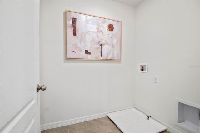 washroom with hookup for a washing machine and light tile patterned floors