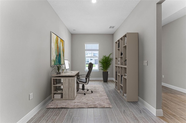 office area with a textured ceiling