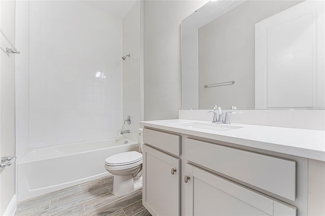 full bathroom with tiled shower / bath, vanity, and toilet