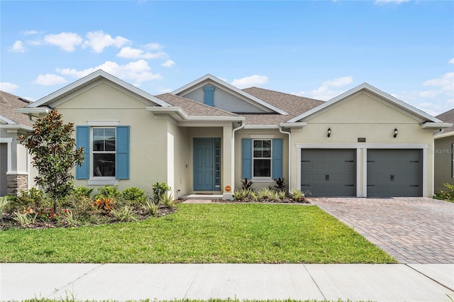 ranch-style house with a garage and a front yard