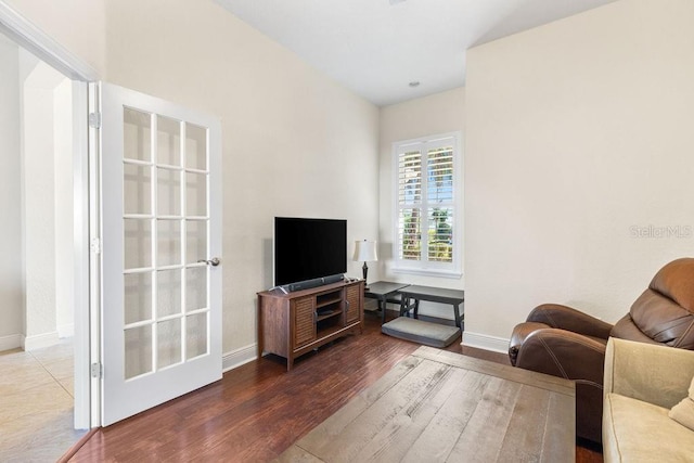 living room featuring wood finished floors and baseboards