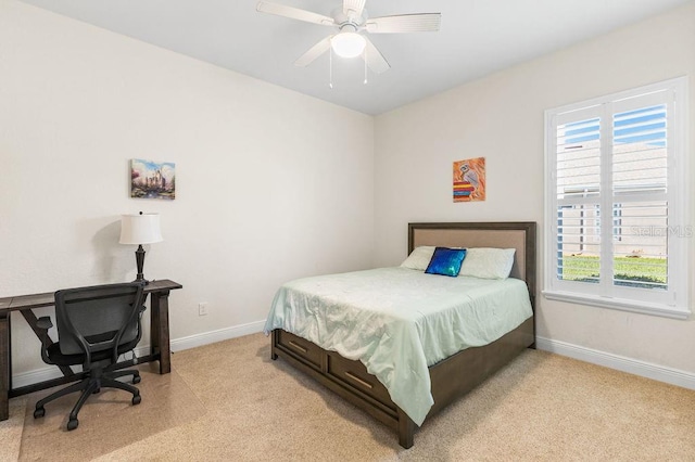 bedroom with light carpet, baseboards, and a ceiling fan