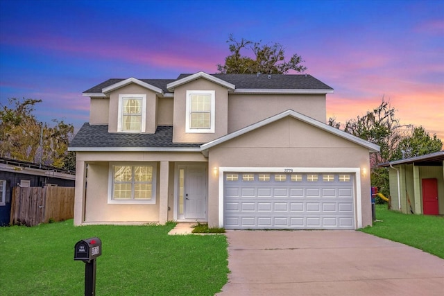 view of front of property featuring a garage and a yard