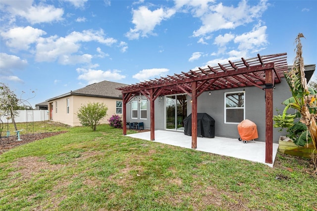 rear view of house featuring a yard, stucco siding, a patio area, fence, and a pergola