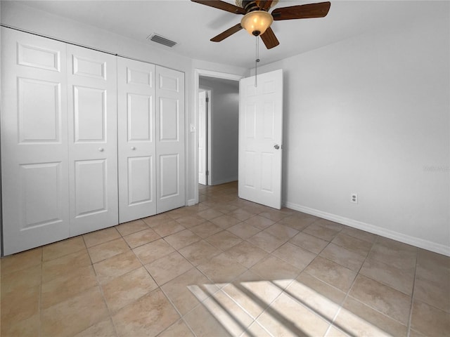 unfurnished bedroom featuring light tile patterned flooring, ceiling fan, and a closet