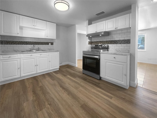 kitchen with electric stove, sink, dark hardwood / wood-style floors, and white cabinets