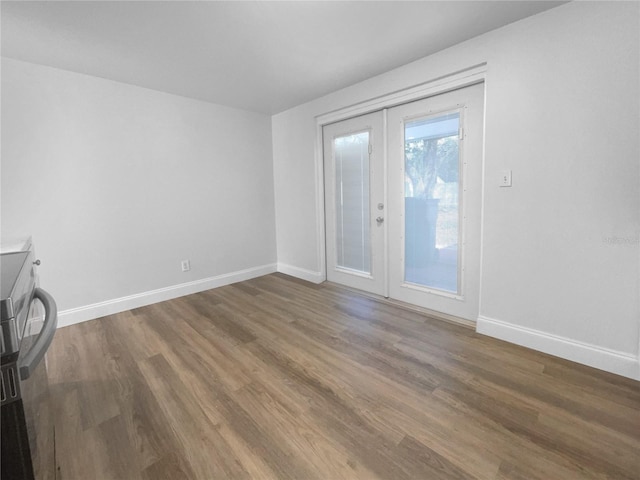 unfurnished living room featuring hardwood / wood-style floors and french doors