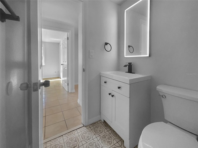 bathroom with vanity, toilet, and tile patterned flooring