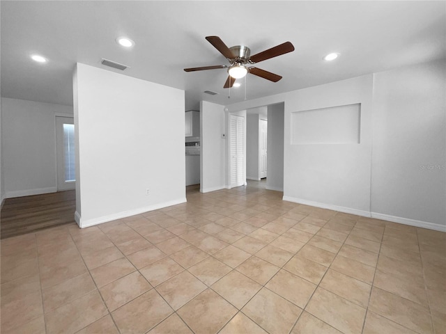 spare room with light tile patterned floors and ceiling fan