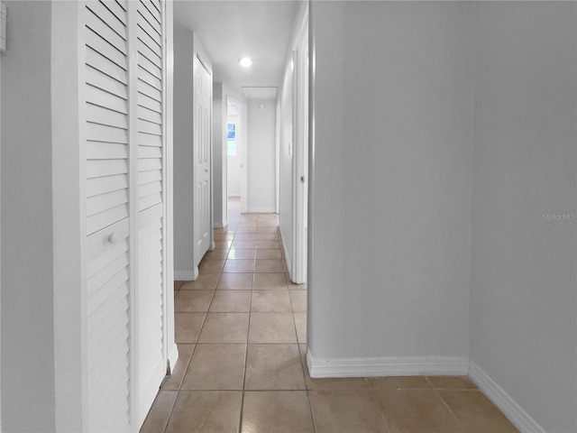 913 27th St E, Bradenton, FL 34208 - hallway featuring light tile patterned floors, baseboards, and recessed lighting