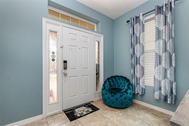 entryway featuring a wealth of natural light and baseboards