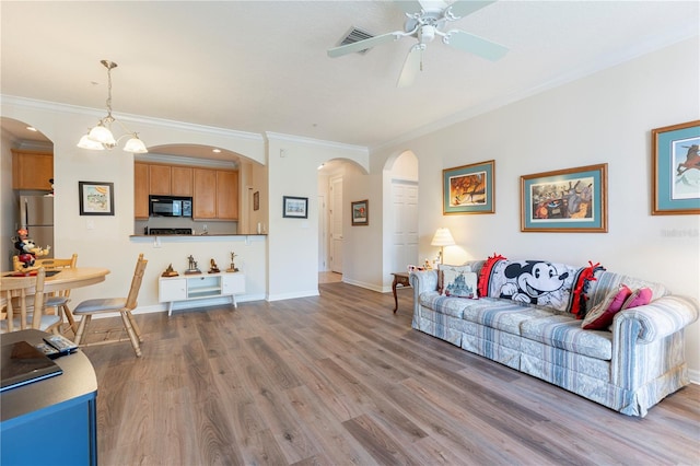 8168 Boat Hook Loop Unit 707, Windermere, FL 34786 - living area featuring arched walkways, crown molding, ceiling fan, and wood finished floors