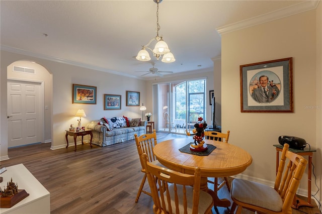 8168 Boat Hook Loop Unit 707, Windermere, FL 34786 - dining area featuring crown molding, a chandelier, arched walkways, wood finished floors, and ceiling fan