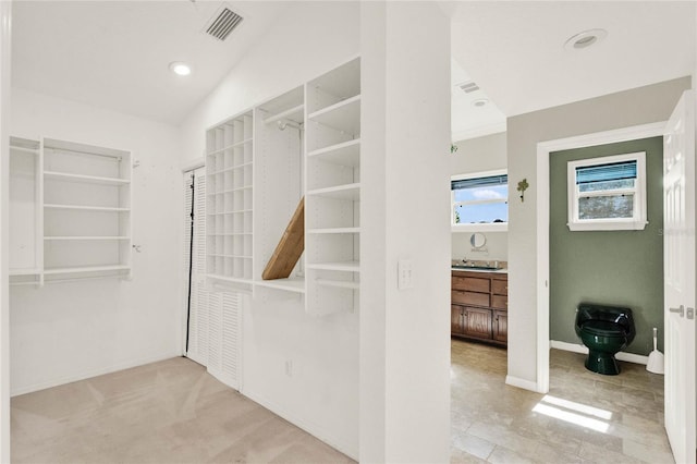 walk in closet featuring visible vents and light colored carpet