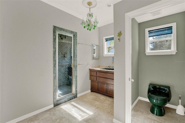 bathroom featuring ornamental molding, a stall shower, vanity, and baseboards