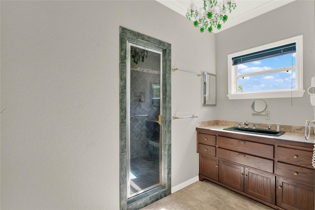 bathroom featuring a stall shower, vanity, and baseboards