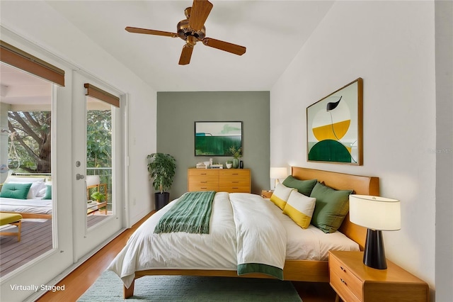 bedroom with access to outside, a ceiling fan, wood finished floors, and french doors