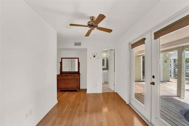 interior space featuring light wood-style floors, baseboards, visible vents, and french doors